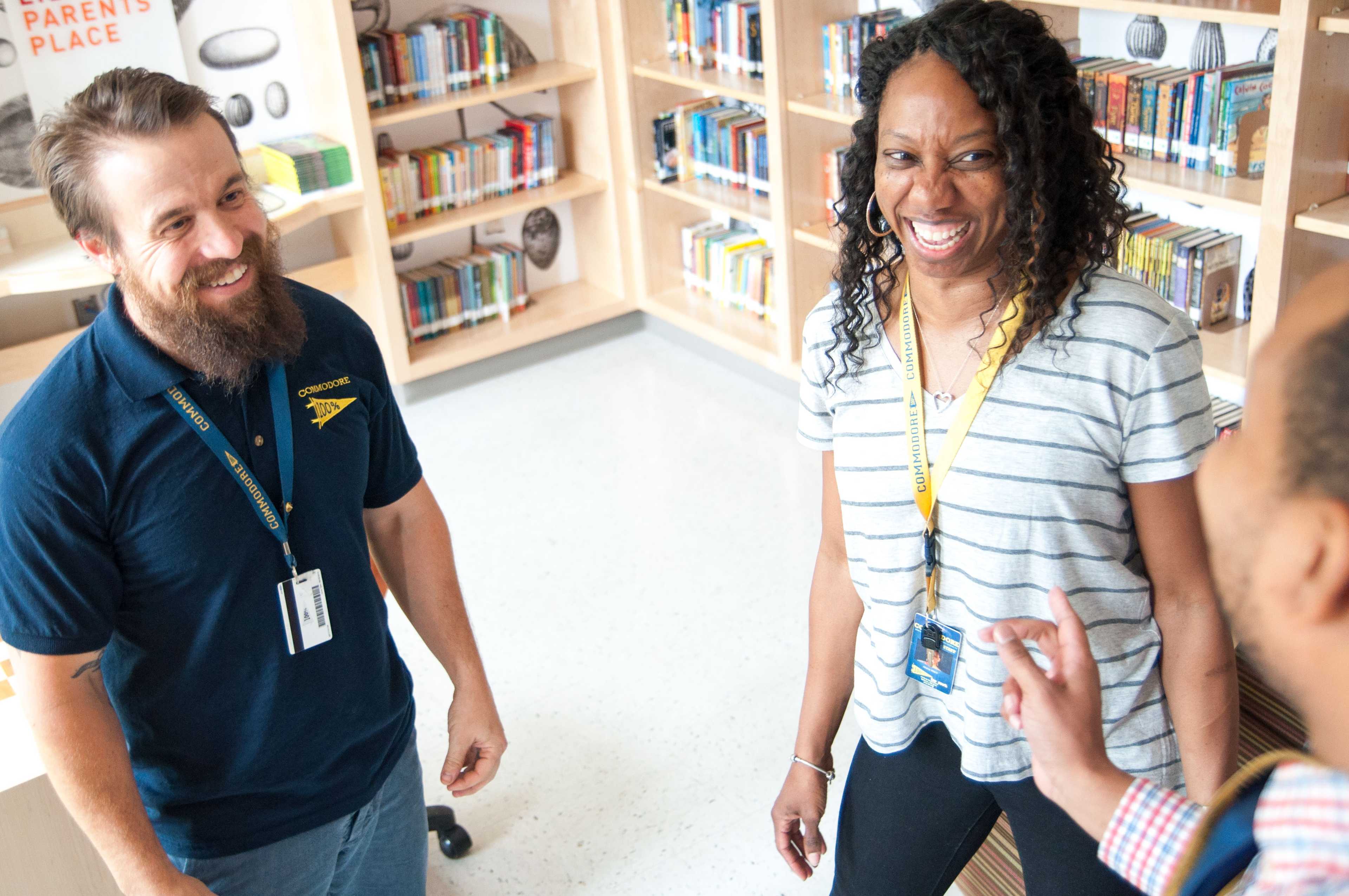 Three teachers standing in a room laughing